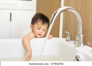 Asian Kid In The Bathroom With Bathtub