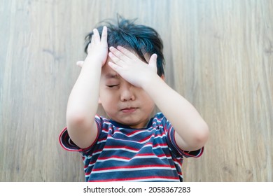 Asian kid boy headache and Accident.Foster child with bad family.Sibling rivalry fighting.School Home harassment.Accident in toddler child kid.Insurance.epilepsy child.Brain injury.emergency.first aid - Shutterstock ID 2058367283