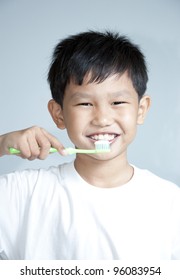 Asian Kid Brushing Teeth Close Up.