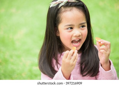 Asian Kid Eating Cookie