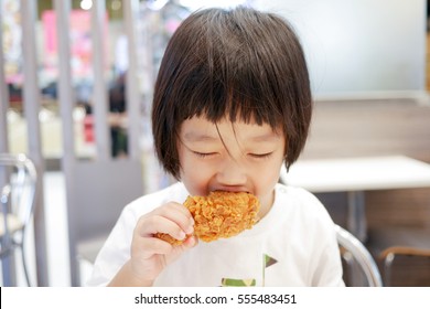 Asian Kid Eating Deep Fried Chicken