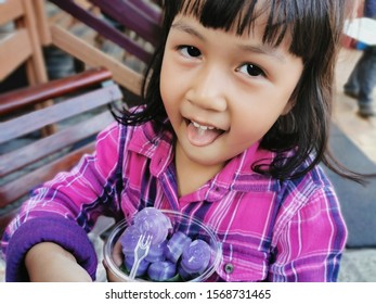 Asian Kid Eating Asian Snacks