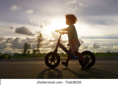 Asian Kid First Day Play Balance Bike. Little Boy Learning To Ride With Bicycle. 