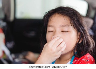 Asian Kid Girl Covers Her Nose Because Of Her Sibling Farting Make A Bad Smell On The Car, Travel With Fart.Digestive Diarrhea.Kid Runny Nose And Sick.Kid Girl Suffering From Bloating And Flatulence.