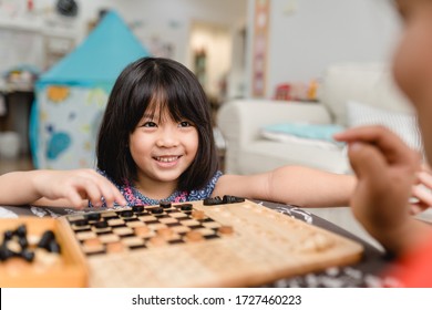 Asian Kid Girl And Mother Stay At Home Lockdown From Covid-19 Coronavirus Crisis Are Playing Chess While Spending Time Together At Home.Smart Kid Home School Kid With Mom.Stay Home Stay Safe With Mom.