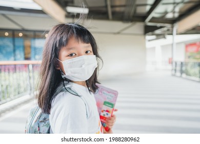 Asian Kid Girl Student Wearing Face Mask.student Kid Girl Walking In School.Reopen School Back To School During Covid19 Coronavirus.Medical Mask Lifestyle.Education Healthcare.Primary School Child.