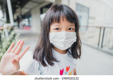 Asian Kid Girl Student Wearing Face Mask.student Kid Girl Walking In School.Reopen School Back To School During Covid19 Coronavirus.Medical Mask Lifestyle.Education Healthcare.Primary School Child.