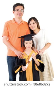 Asian Kid In Graduation Gown.Taking Photo With Family.