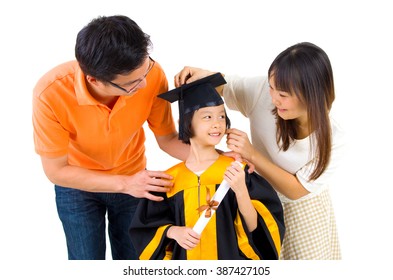 Asian Kid In Graduation Gown.Taking Photo With Family.