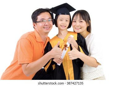 Asian Kid In Graduation Gown.Taking Photo With Family.