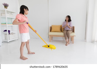 Asian Kid Happy Housework Cleaning Mop The Floor, Mother Appreciate Her Ability