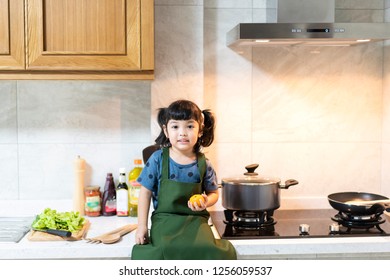 Asian Kid In The Kitchen. Kid Ready To Be The Chef.