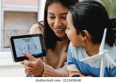 Asian Kid Learning About Alternative Renewable Energy At Kindergarten School Class - Focus On Teacher Hand Holding Tablet