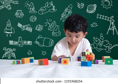 Asian Kid Learning By Playing With His Imagination About Science And Space Adventure, Hand Drawn On The Green Chalkboard, Education Back To School And Discovery Concept Idea.