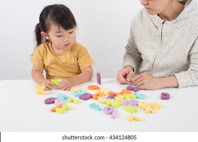 Asian Kid Learning English In Classroom