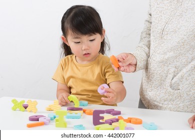 Asian Kid Learning English In Classroom