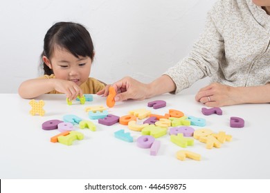 Asian Kid Learning English In Classroom