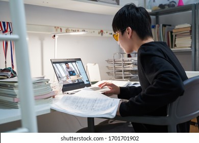 Asian Kid Learning From Home On Laptop In His Bedroom