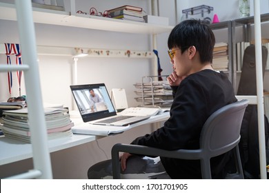 Asian Kid Learning From Home On Laptop In His Bedroom