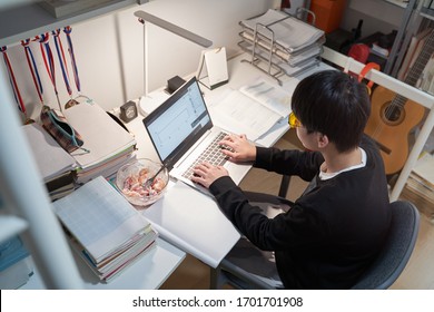 Asian Kid Learning From Home On Laptop In His Bedroom