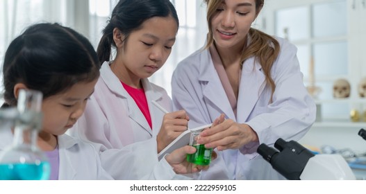 Asian Kid Learning With Scientist In The Laboratory. Physical Examination And Science Education Class.