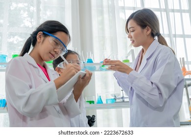 Asian Kid Learning With Scientist In The Laboratory. Physical Examination And Science Education Class.