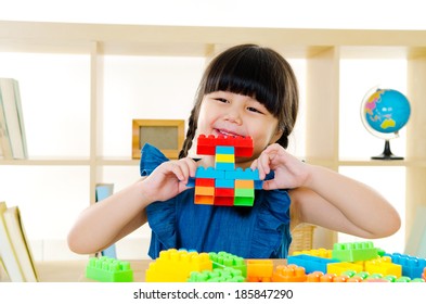 Asian Kid Piling Up Building Blocks