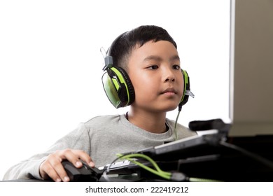 Asian kid play computer internet games and wear headset to communicate - Powered by Shutterstock