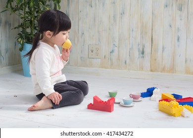 Asian Kid Playing On The Floor