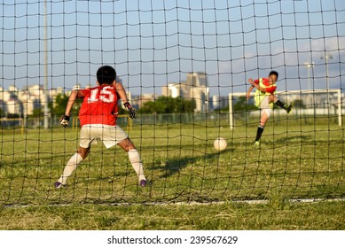 Asian Kid Playing Soccer