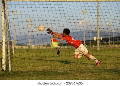 Asian Kid Playing Soccer