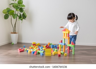 Asian Kid Playing With Toys