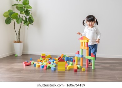 Asian Kid Playing With Toys