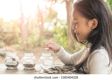 Asian Kid Saving Money Putting Coins Into Glass Bank, Hand Of Little Girl Putting Coins In Jar With Money Stack Step Growing Growth Saving Money, Concept Finance Business Investment, Money Saving