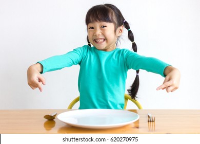 Asian Kid With Spoons And Forks.