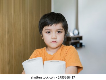 Asian Kid Suffering From Stomachache Problem By Eating Contaminated Food,Sad Child Has Stomach Pain With Food Poisoning,Kid Holding Toilet Rolls,Children With Severe Abdominal Pain, Tummy Bug Concept