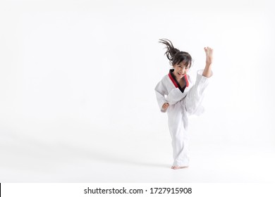Asian kid Taekwondo kicking in white studio 