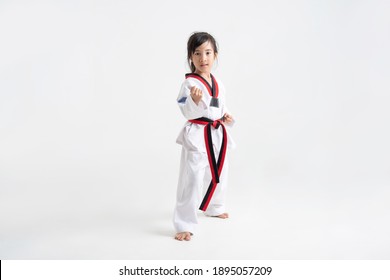 Asian Kid Taekwondo In White Studio 