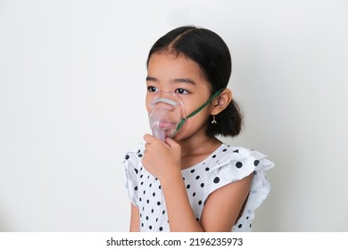 Asian Kid Using Mask During Nebulizer Treatment