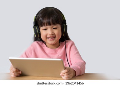 Asian Kid Watching Something On Tablet Computer