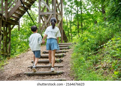 Asian Kids Climbing Stairs In Nature