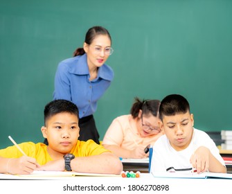 Asian kids with disability in special school classroom with Autism child and attractive teacher