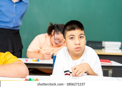 Asian kids with disability in special school classroom with Autism child and attractive teacher