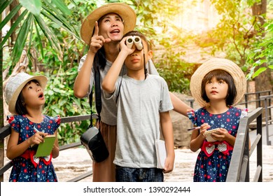 Asian Kids Family Learning Outdoor On Vacation Summer, Kid Funny Family Are Mother Brother And Sisters Looking Animals In Zoo, Sister Holding Pen And Notebook For Writing, Brother Looking Telescope 