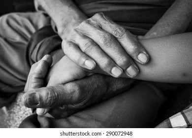 asian kids little boy  touches and holds hand old man ,black and white tone
