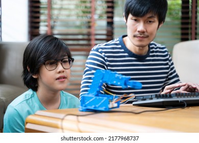 Asian Kids Program Robotic Cranes With Laptops To Learn About Technology, Math, Engineering. Programming And Coding At Home