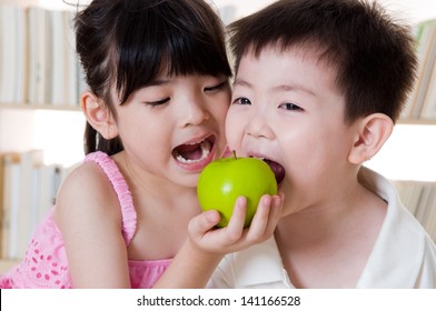 Asian Kids Sharing An Apple