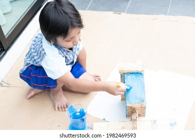 Asian Kindergarten Boy Painting On A DIY Craft Project.