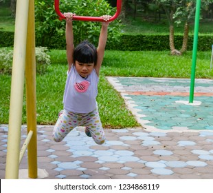 An Asian Kindergarten Girl Plays A Monkey Bar At The Playground Alone 