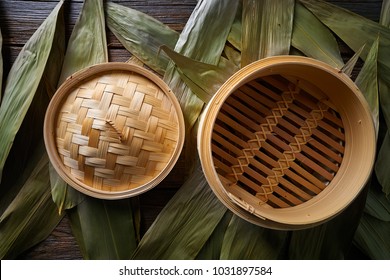 Asian kitchen bamboo steamer for steam cooking recipes on leafs